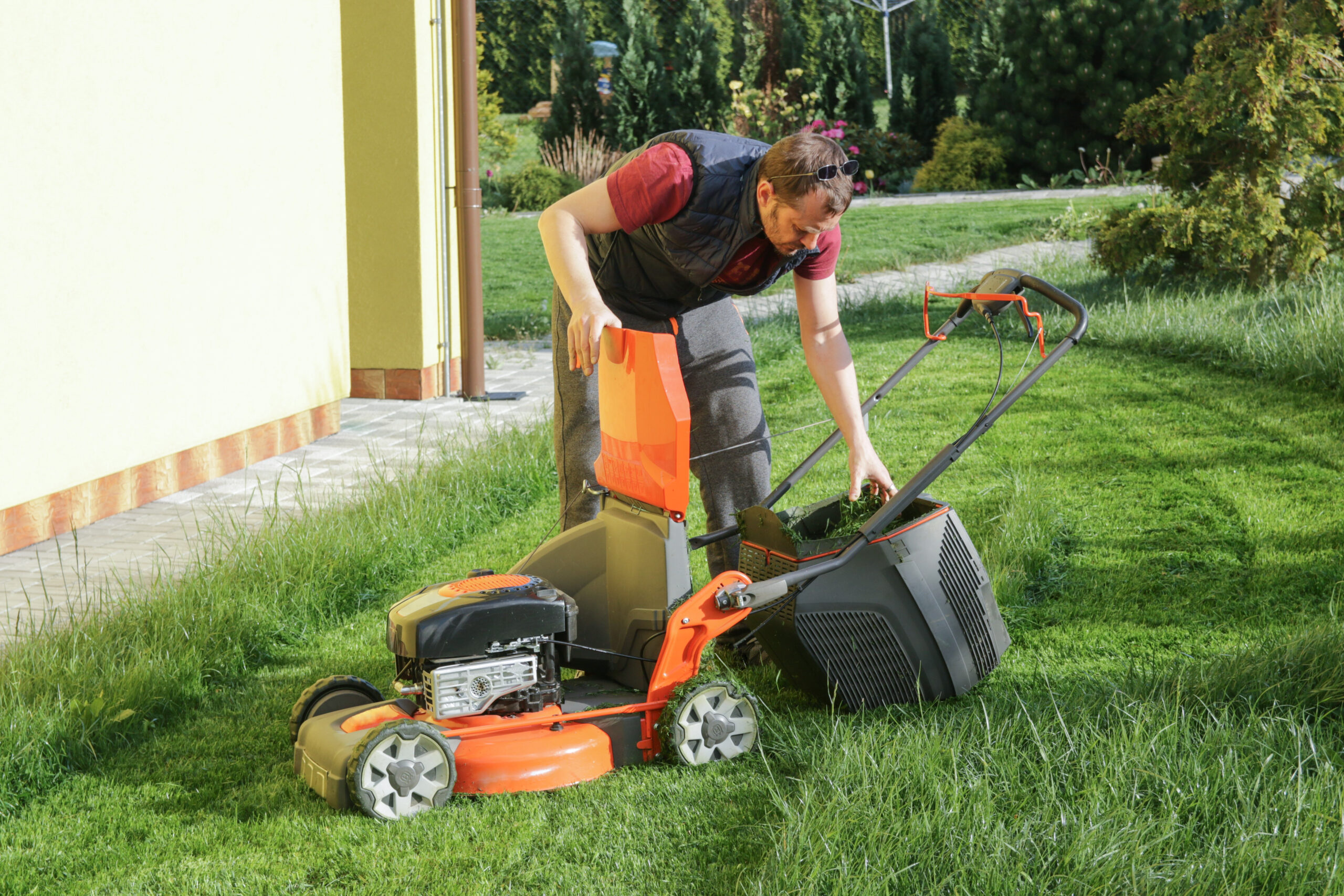 man mowing lawn in the backyard
